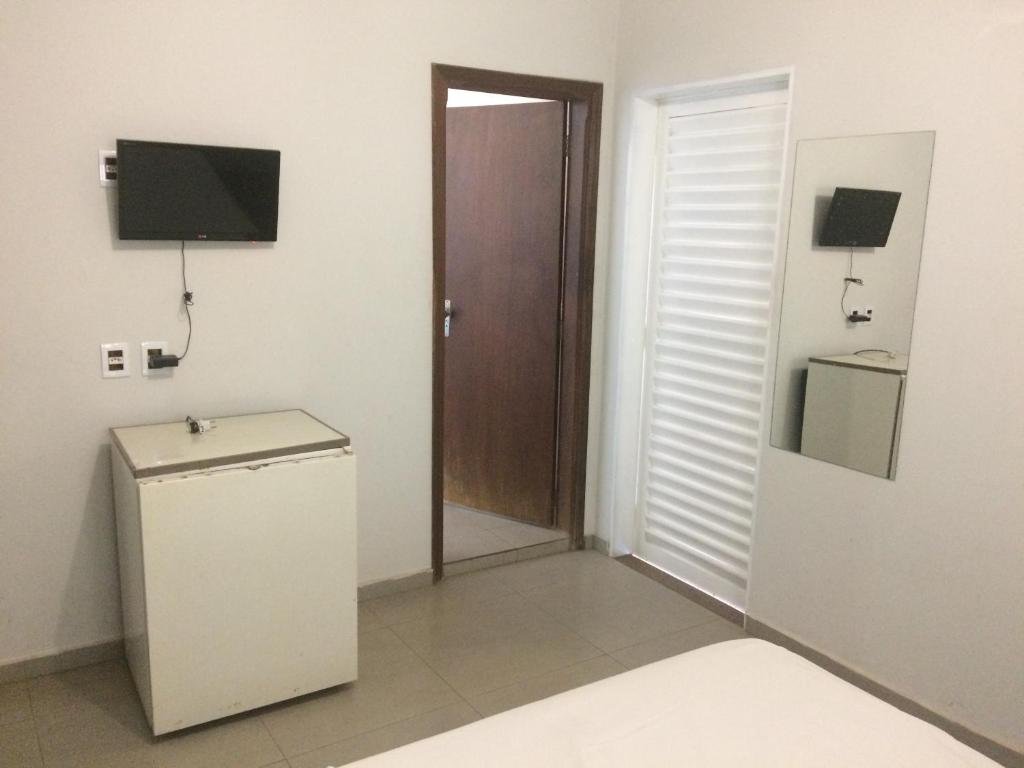 Family room with flat-screen TV, refrigerator and private bathroom door